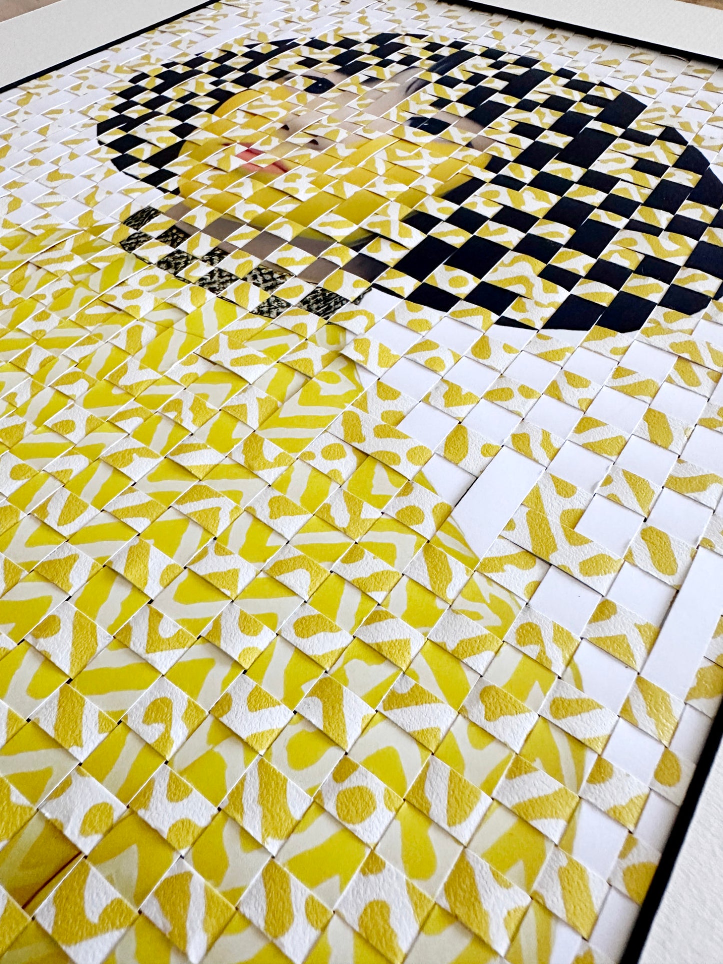 Close up detail on woven portrait of a woman in yellow