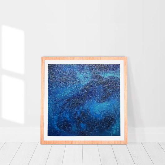 bold blue print of an original abstract painting framed in a room
