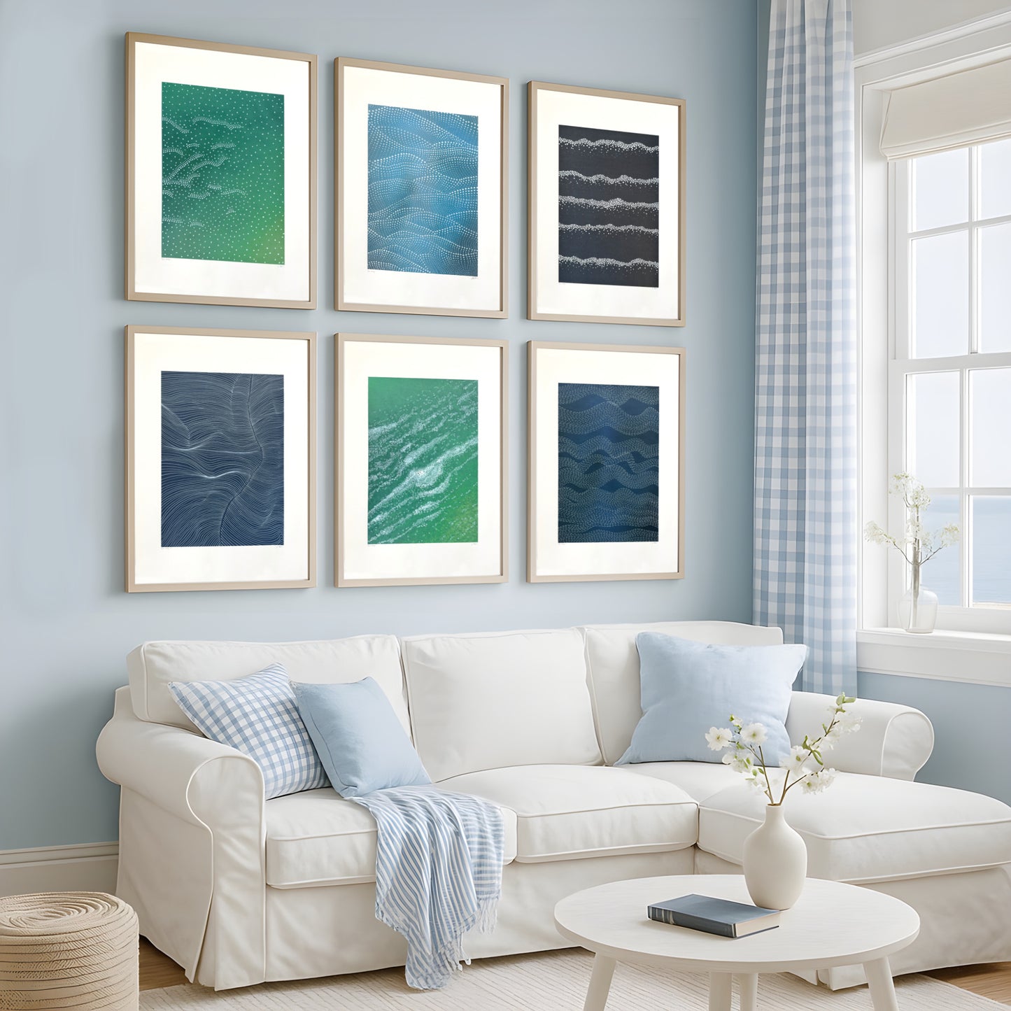 Set of six abstract wave-inspired paintings by Jennifer Bell displayed in a coastal-style interior with shades of blue and green