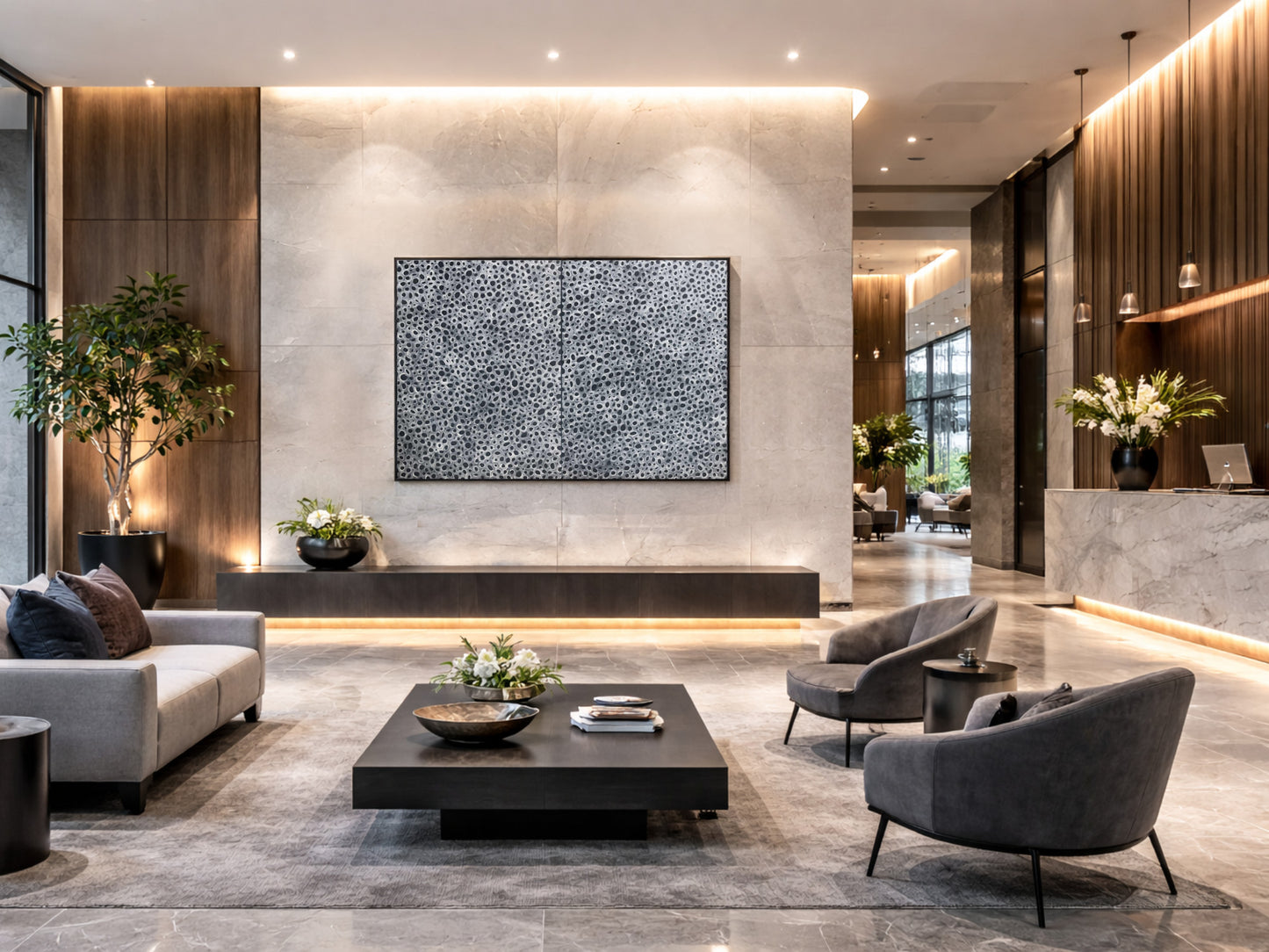 Large black and white abstract diptych wall art in a contemporary hotel lobby interior design, neutral commercial styling with stone, timber and modern seating.
