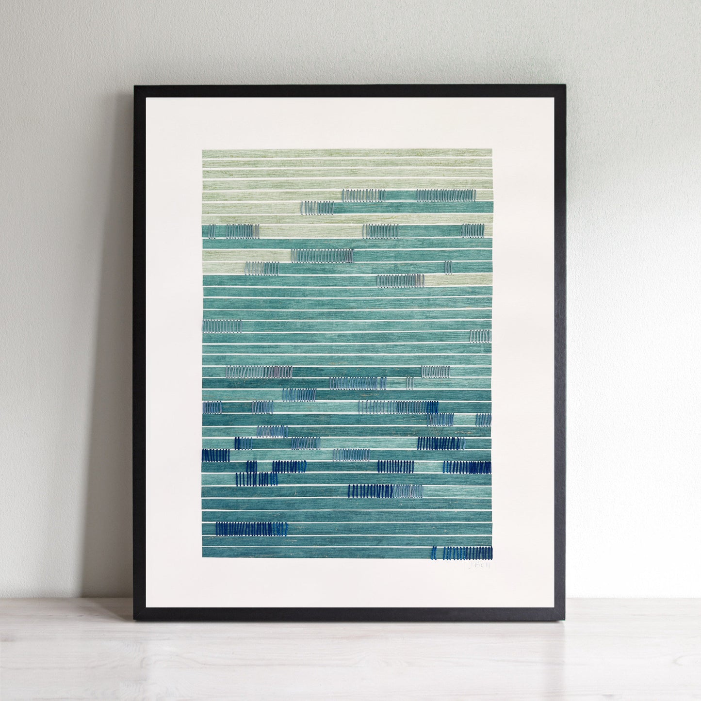 blue abstract wall art with blue and green stripes on a white wall