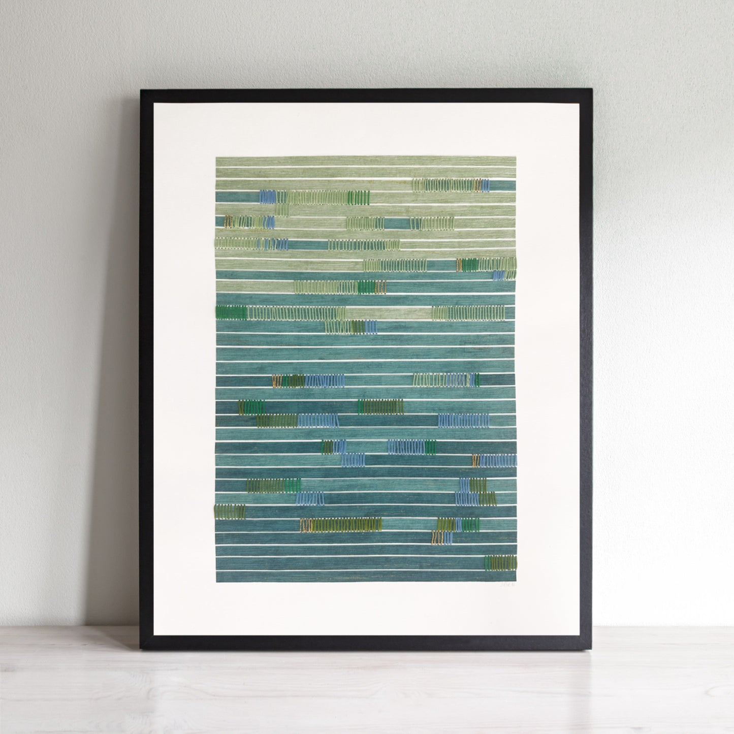 Abstract art with horizontal paper strips in green and blue and hand stitching