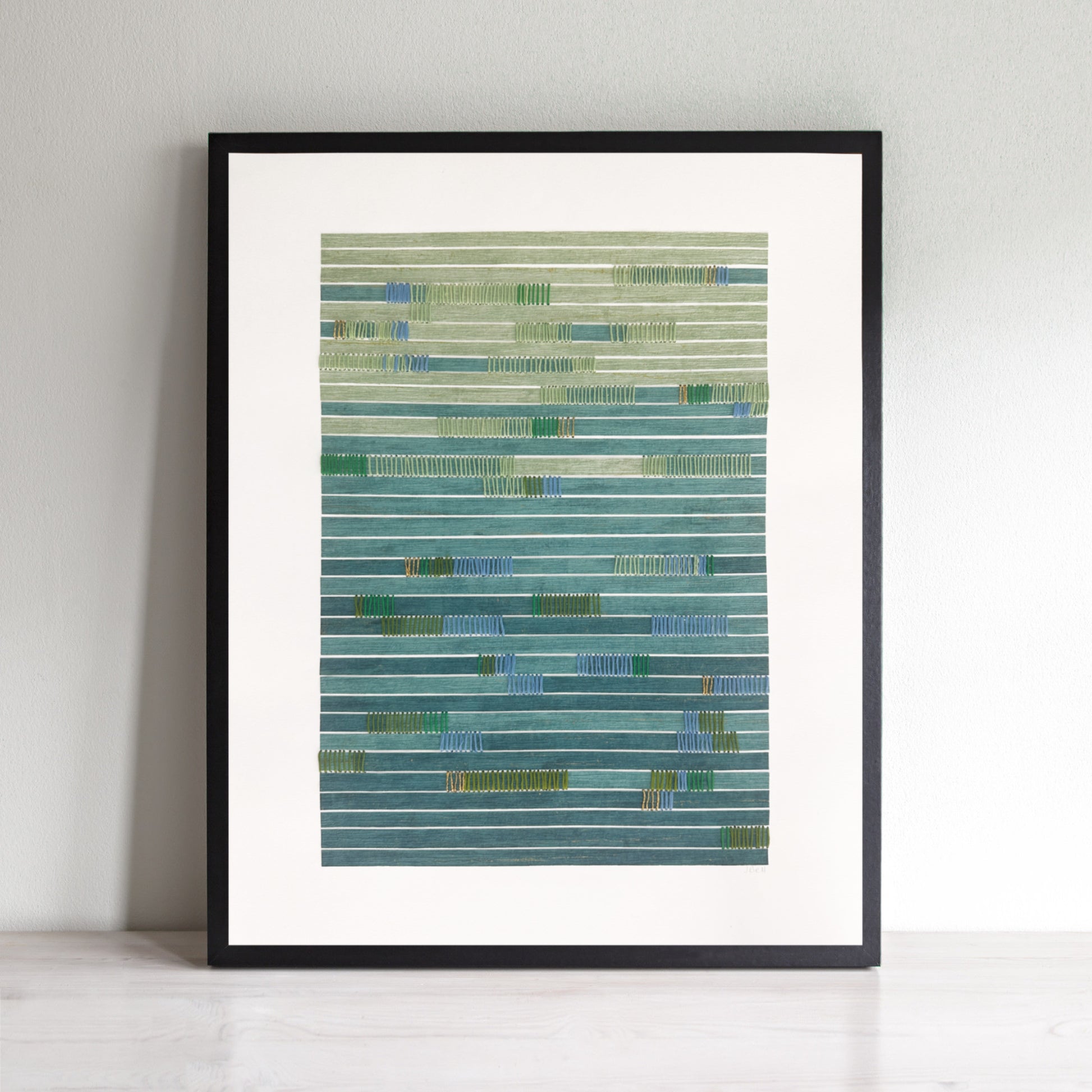 Abstract art with horizontal paper strips in green and blue and hand stitching