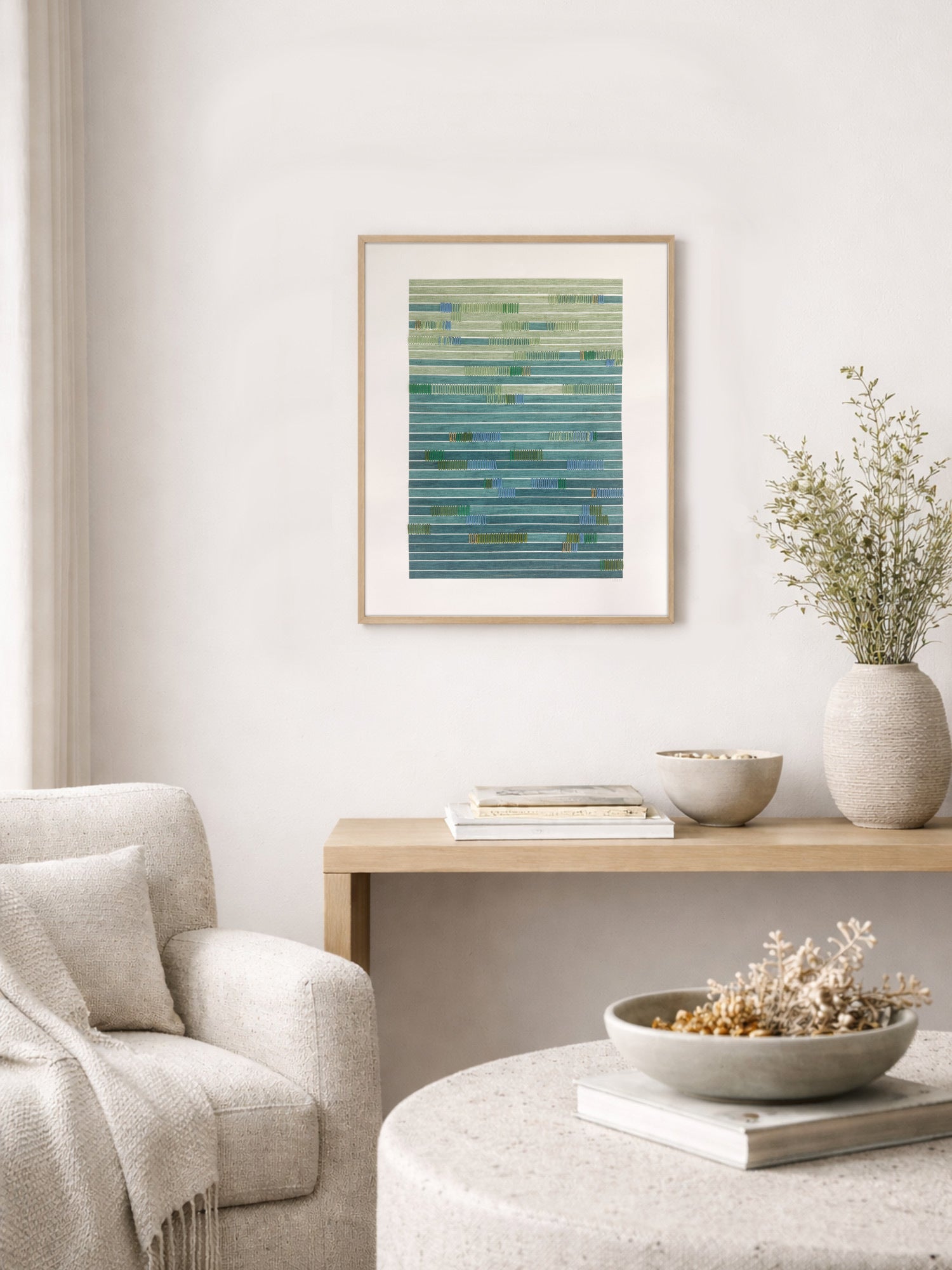 Living room with a framed artwork, books, and decorative items on a table.