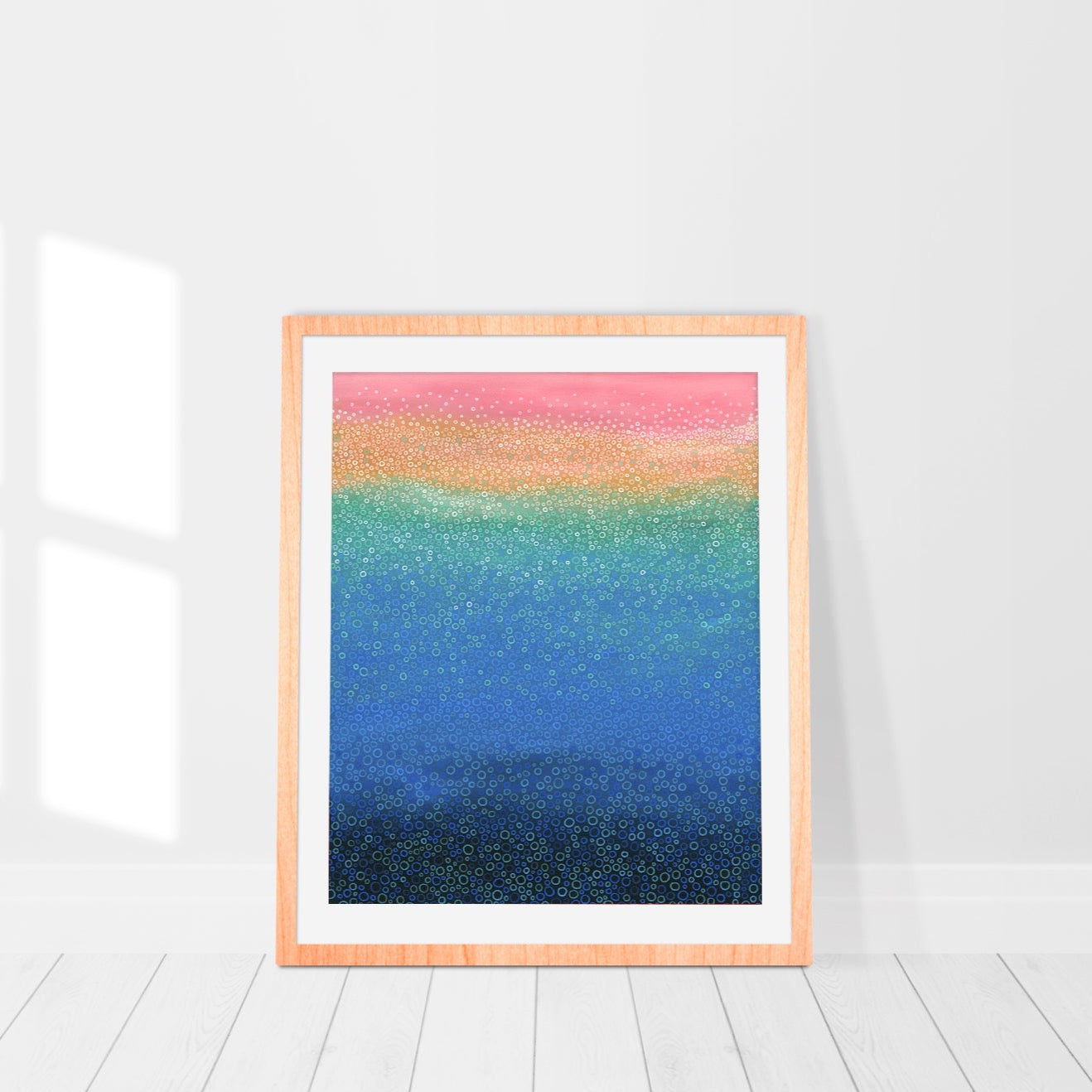 Colourful print in frame withblues, soft pinks and turquoise. Abstract pointillism.