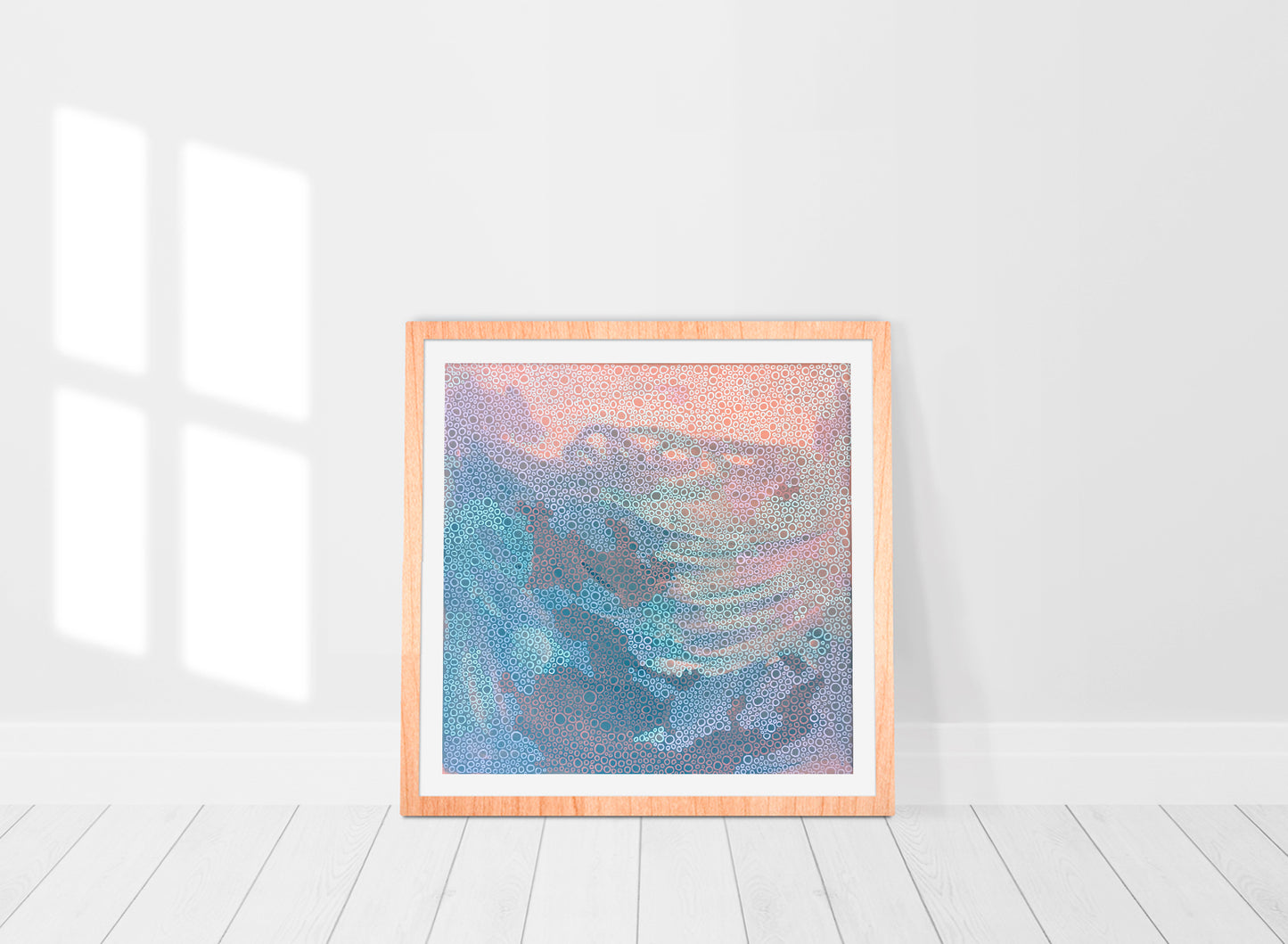 abstract print in a frame in a mix of pinks, corals and greys 