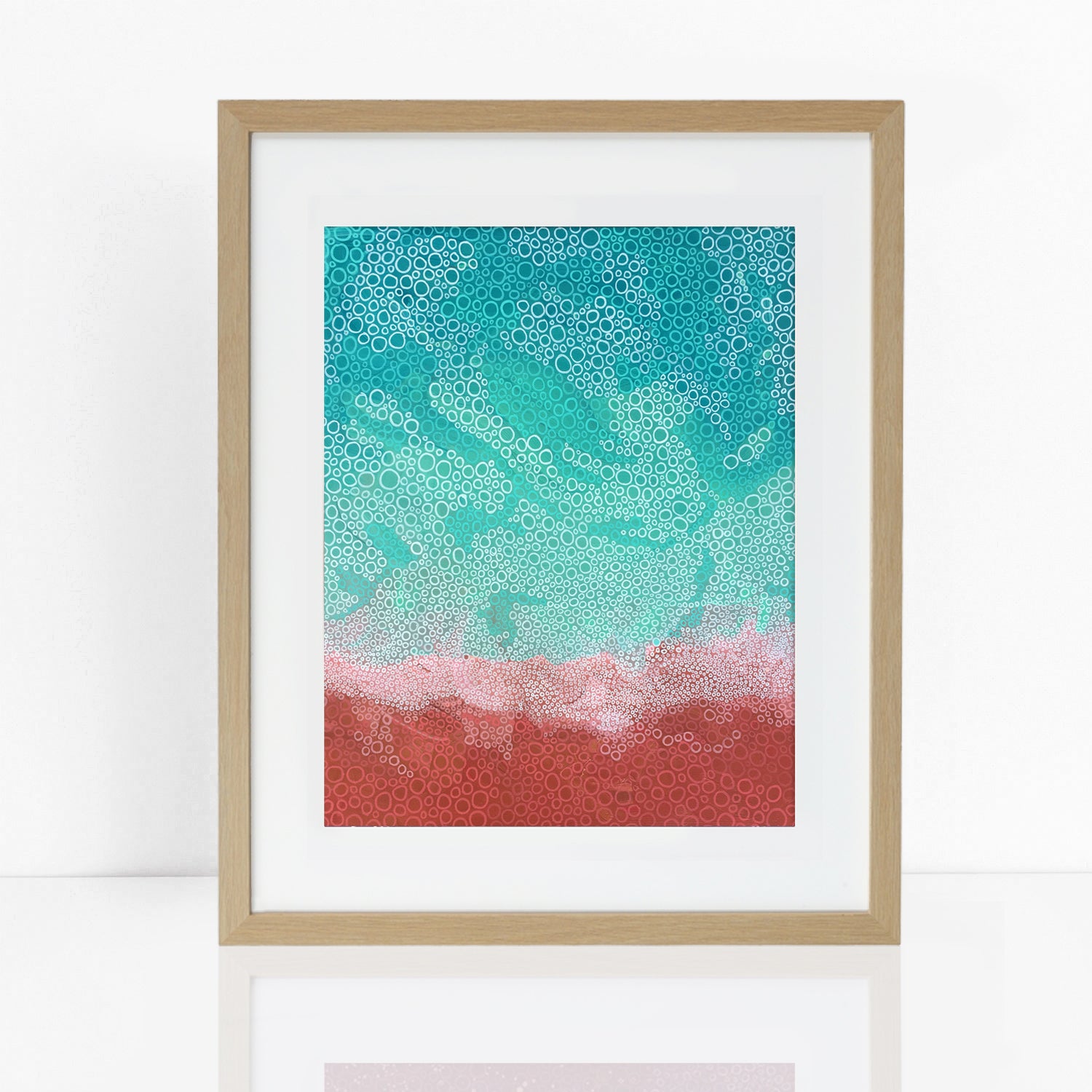 print in frame of abstract Australian coastal image from above with red rocks and aqua sea