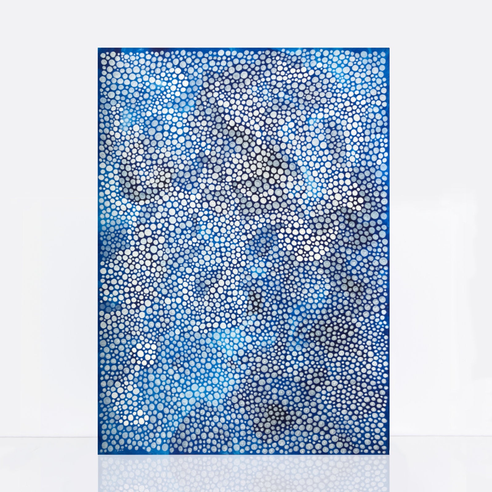 vivid blue artwork adorned with intricate white dots of various sizes, reminiscent of sea bubbles and foam