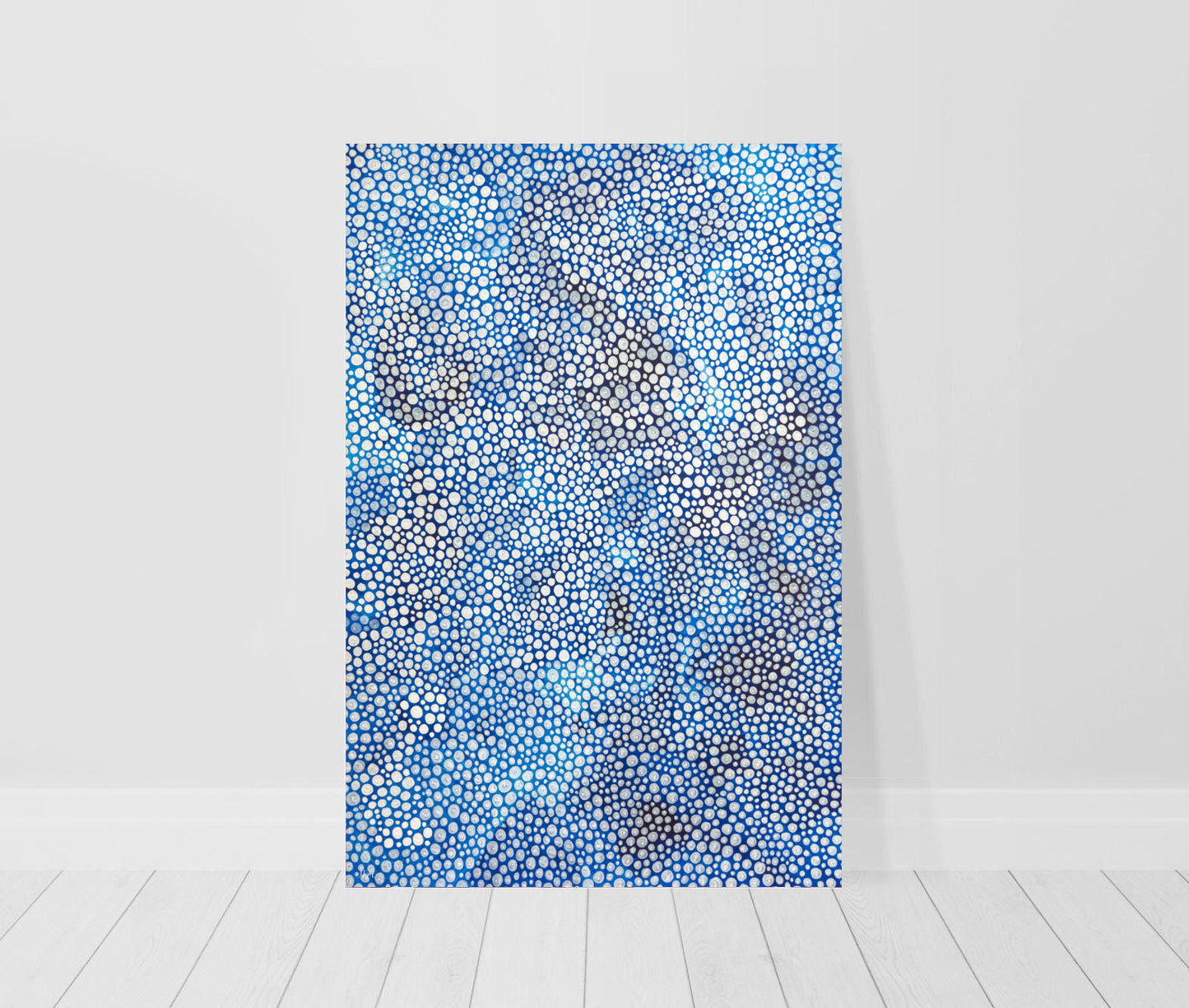 limited edition print of a blue abstract dot painting leaning against a wall
