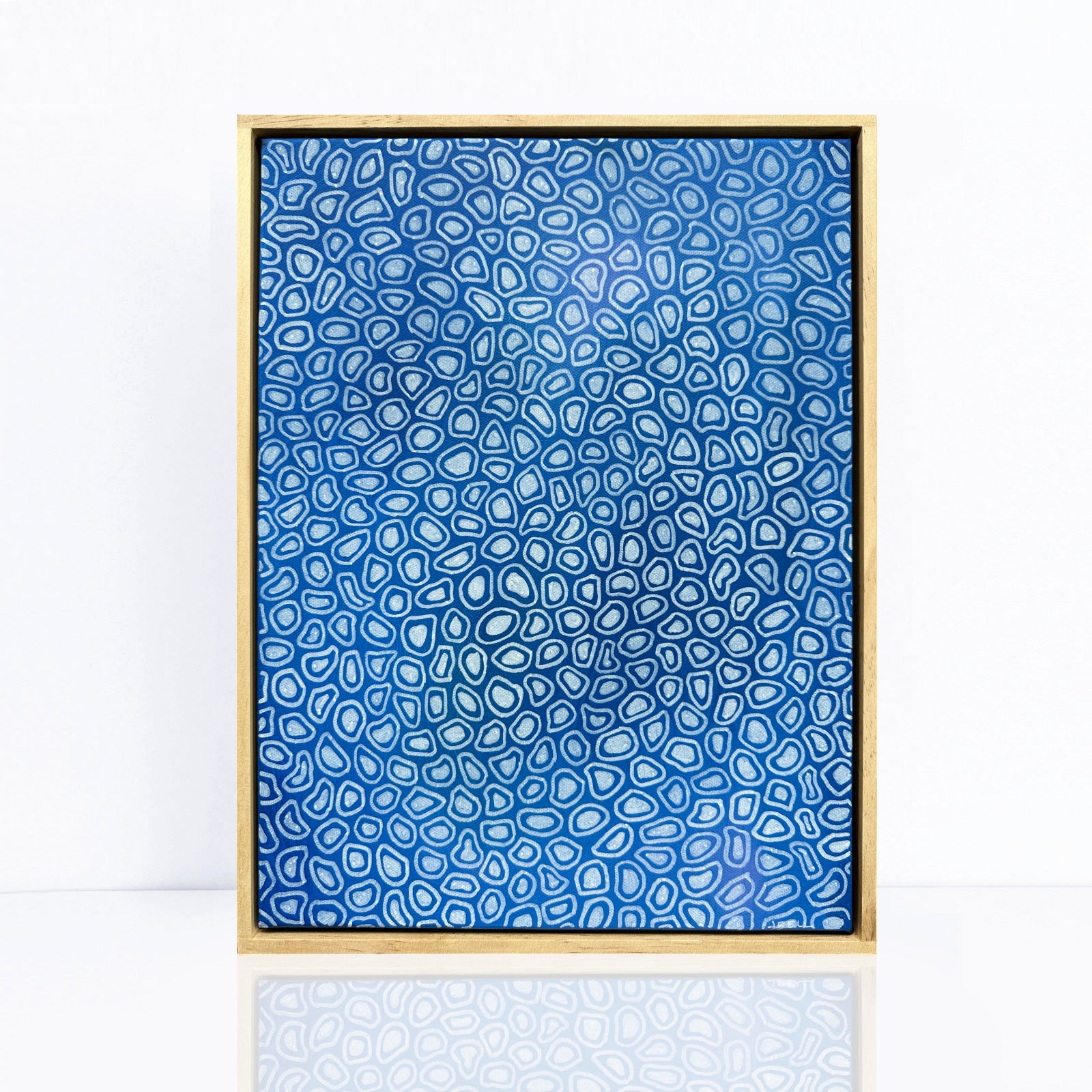 blue framed abstract painting with  intricate designs or organic shapes