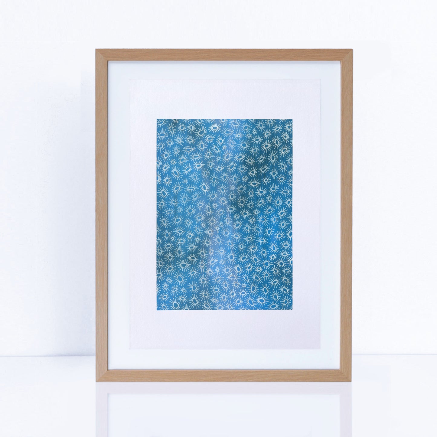 tranquil artwork in blues and delicate white design in a frame