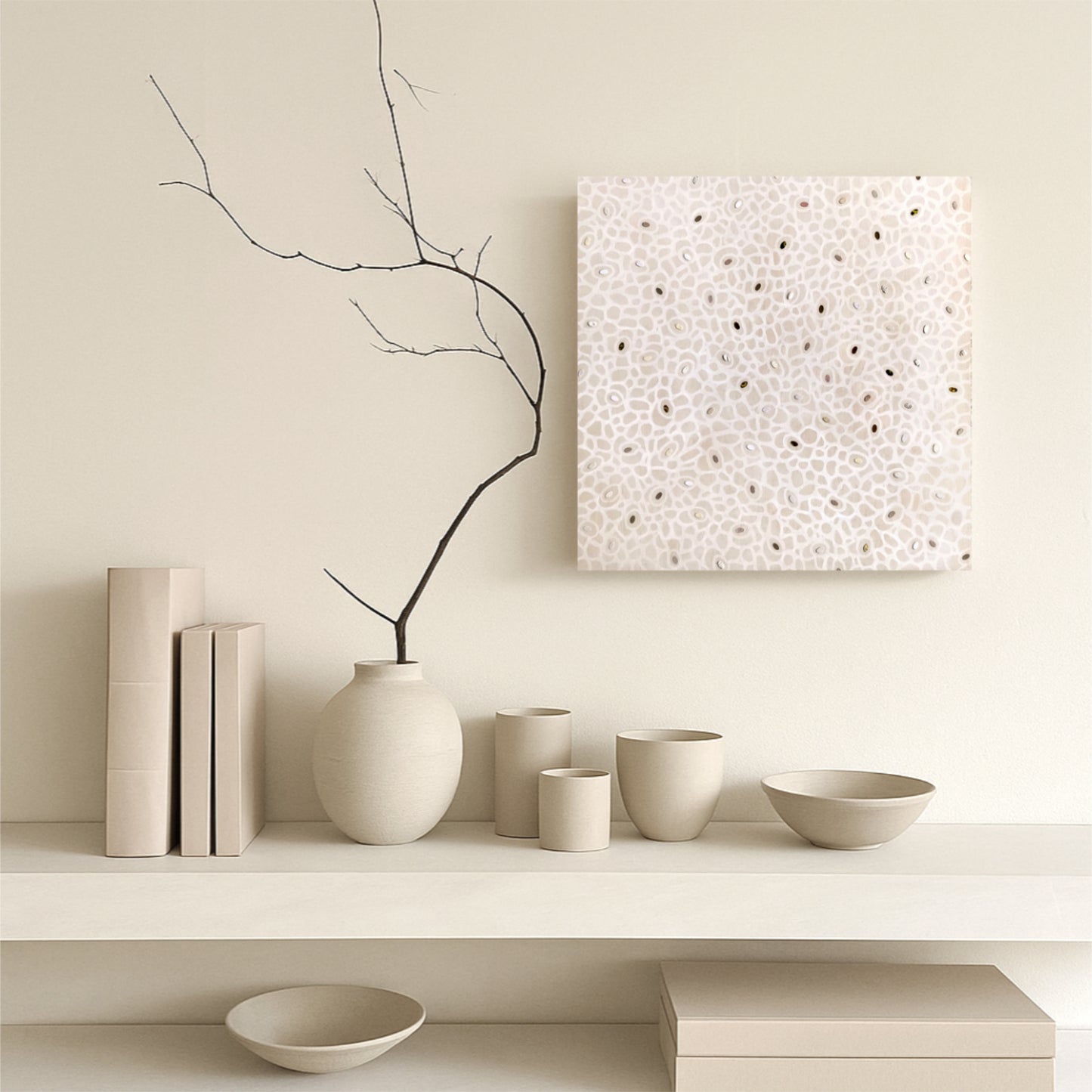 Minimalist interior with neutral-colored vases, bowls, and a branch on a shelf and Japani style artwork