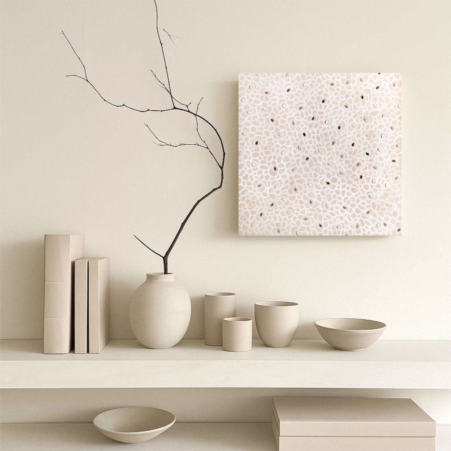 Minimalist interior with neutral-colored vases, bowls, and a branch on a shelf and Japani style artwork