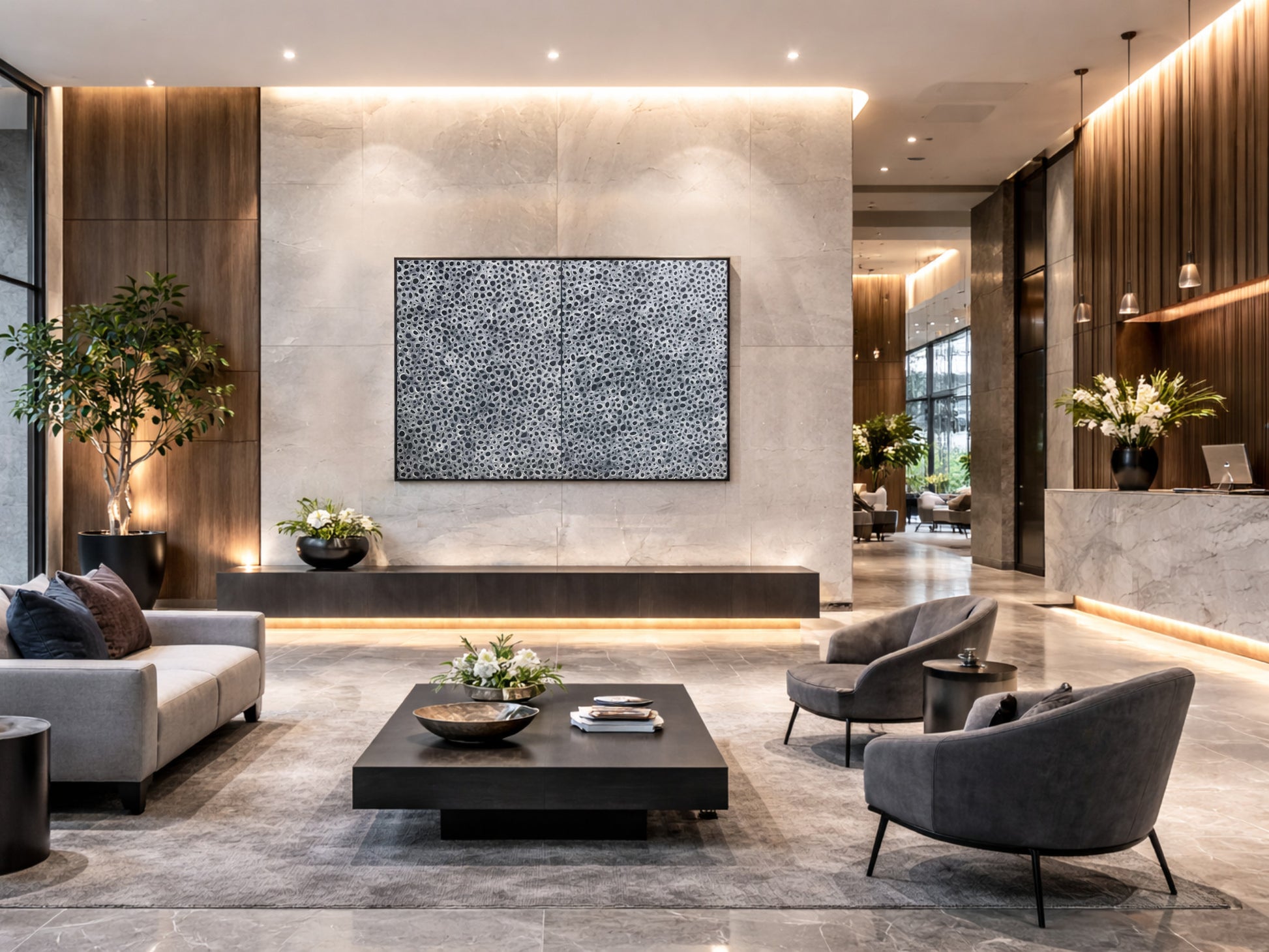 Large black and white abstract diptych wall art in a contemporary hotel lobby interior design, neutral commercial styling with stone, timber and modern seating.