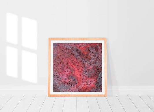 red abstract art print in frame in a room